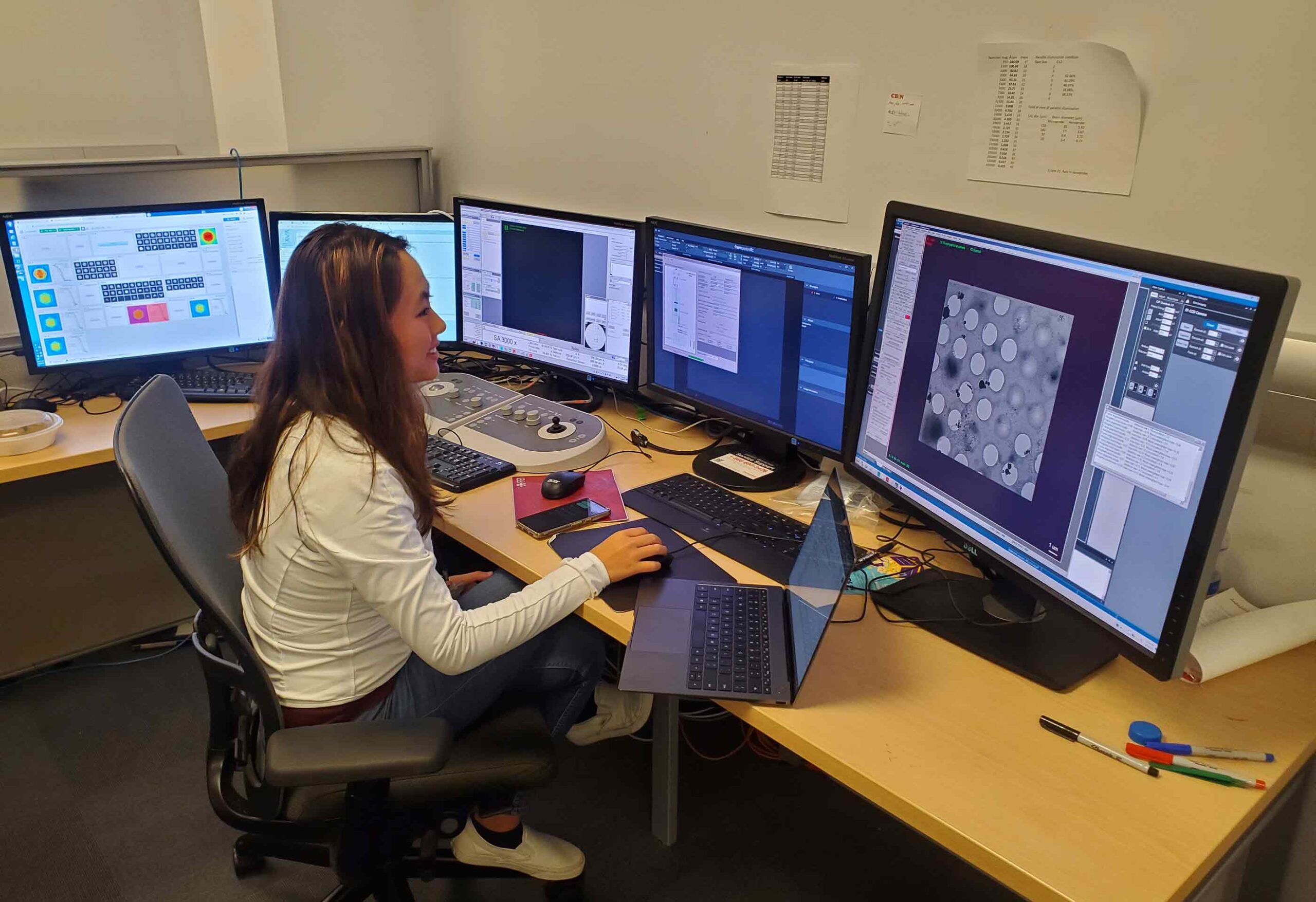 As part of her doctoral dissertation studies, Jennifer Jiang works in an electron microscope control room in the Rutgers CryoEM and Nanoimaging Facility. A new program being developed by the Rutgers-New Brunswick Office of the Chancellor will greatly expand the availability of such research opportunities for undergraduates, graduate students and non-degree students. Jiang is examining a protein that has been frozen through an advanced technique that employs a glassy form of water known as vitreous ice. J. Kaelber/Rutgers CryoEM and Nanoimaging Facility